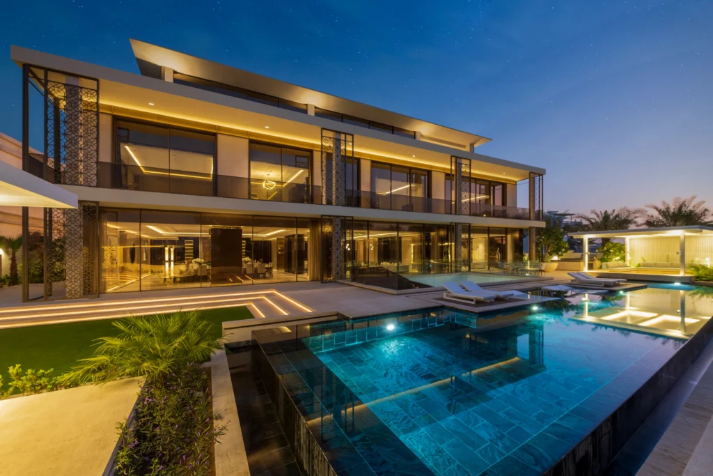 Modern luxury Dubai mansion with illuminated swimming pool and contemporary architecture popular among Australians buying property in Dubai.